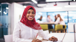 Woman small business owner with hijab learning about market research she needs to do on her niche